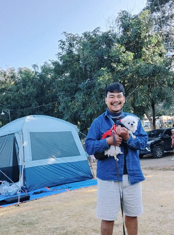 Camping by the Pai River, with a fellow camper and their dog.