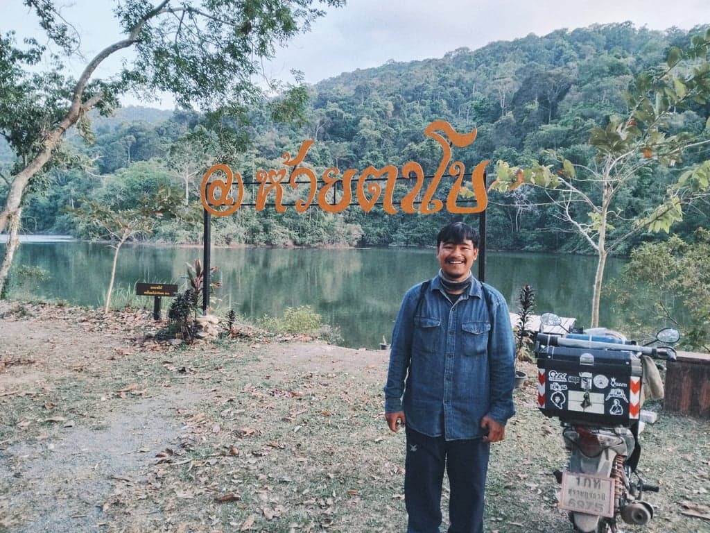 Relaxed camping at Huai Ta Bo Reservoir, Chanthaburi, surrounded by mountains, forests, and water.